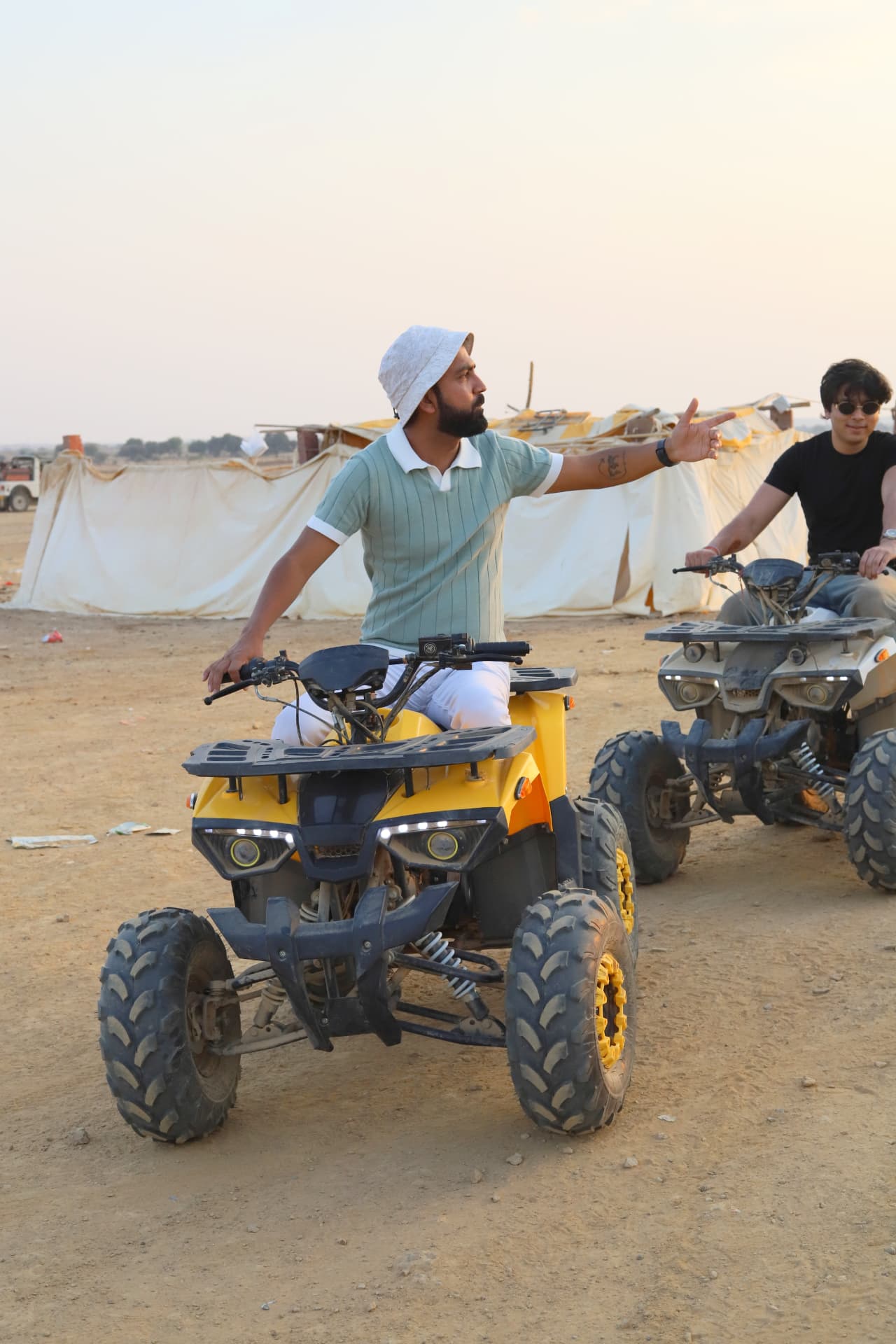 A traveller on a quad bike in the dunes at golden hour