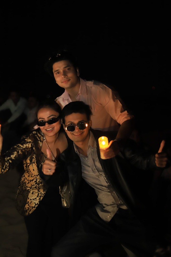 Travellers posing together at a candlelit dinner