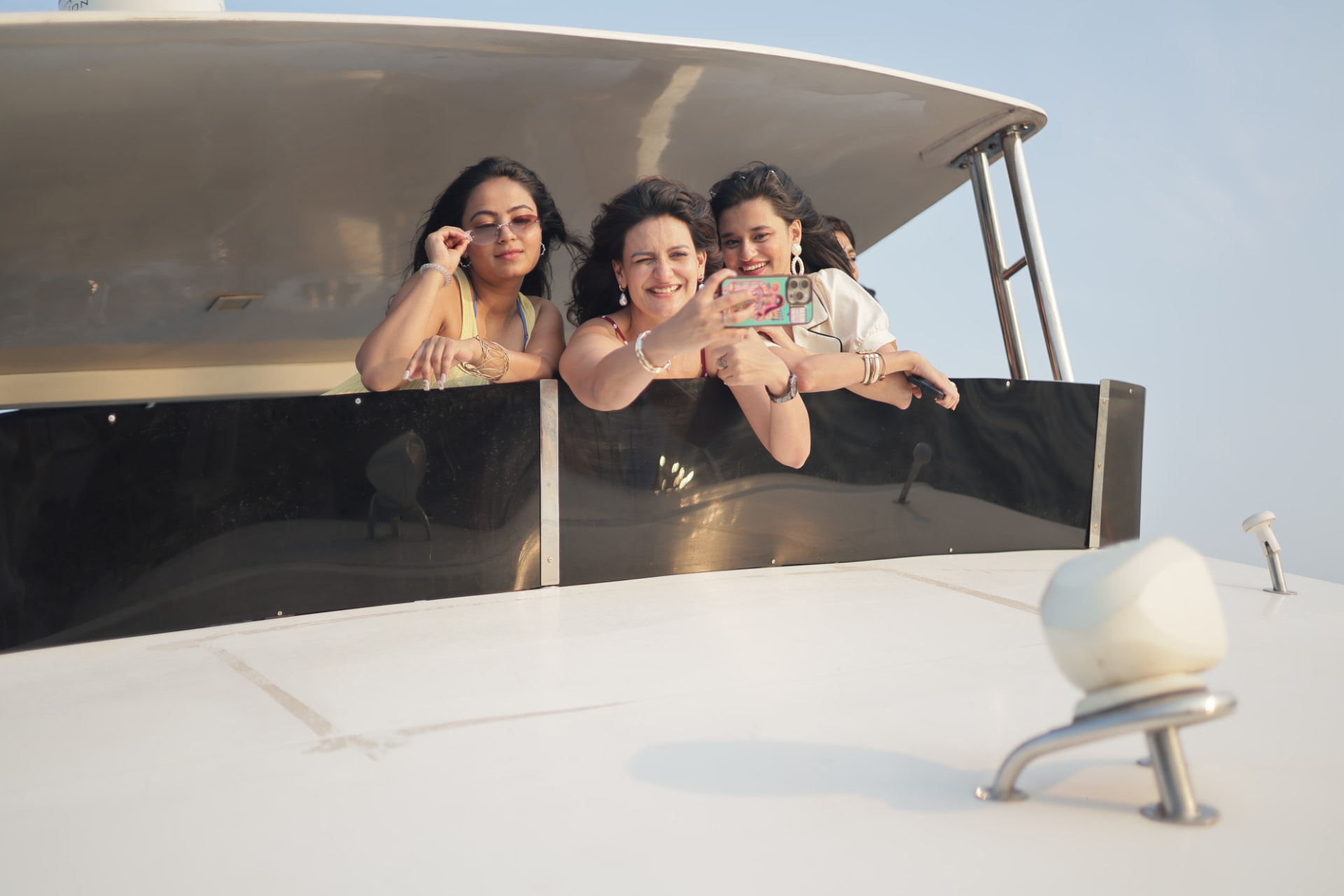 Friends taking a selfie on the deck of a yacht